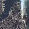 This one-meter resolution satellite image of Manhattan, New York was collected at 11:43 a.m. EDT on Sept. 12, 2001 by Space Imaging's IKONOS satellite. The image shows an area of white and gray-colored dust and smoke at the location where the 1,350-foot towers of the World Trade Center once stood. IKONOS travels 423 miles above the Earth's surface at a speed of 17,500 miles per hour.